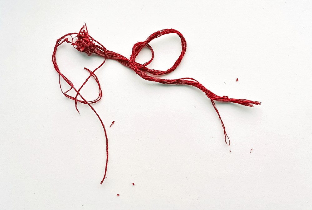 A close-up picture of red thread.